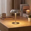 Silver mushroom cordless table lamp on a modern desk