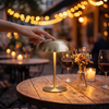 Gold mushroom lamp on a cafe table at dusk