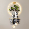 Mountain and waterfall LED wall art shown straight on against a pale wall, gold halo ring lit