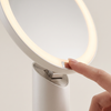 Close detail of the tilting hinge and the touch control at the base of the light ring
