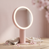 Cherry blossom pink LED vanity mirror on a pale oak dressing table