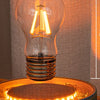 Levitating Edison bulb design floating above the illuminated base
