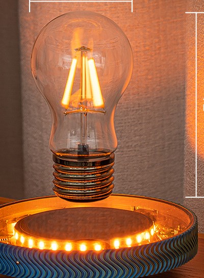 Levitating Edison bulb design floating above the illuminated base