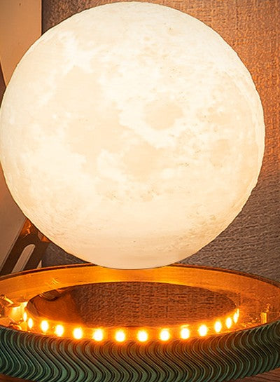 Levitating 3D-printed moon lamp floating and glowing above its illuminated base