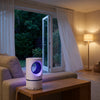 The trap running on a side table in a living room with open doors to a dark garden
