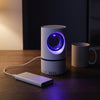 The trap running from a power bank on a desk, about the height of a coffee mug